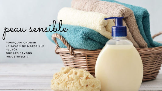 Savon de Marseille doux et naturel pour les peaux sensibles, posé devant un panier de serviettes colorées